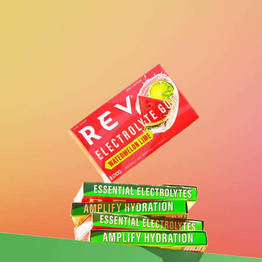 Stack of REVL electrolyte gum packets on a gradient background