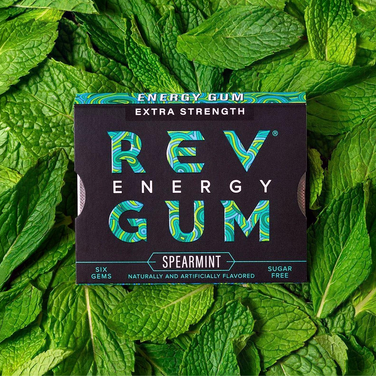 REV Energy Gum packaging on a bed of mint leaves