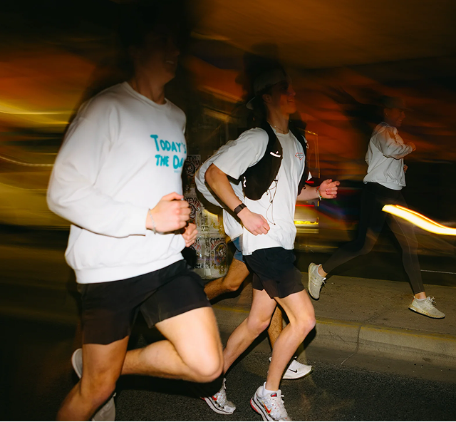 people running with blurred lights in the background and foreground 